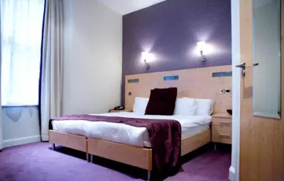 a bedroom with a large bed in a room at Artto Hotel in Glasgow