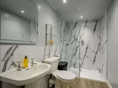 a bathroom with a toilet and a sink at Nith Riverside Cottages in Sanquhar