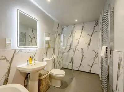 a bathroom with a toilet and a sink at Nith Riverside Cottages in Sanquhar