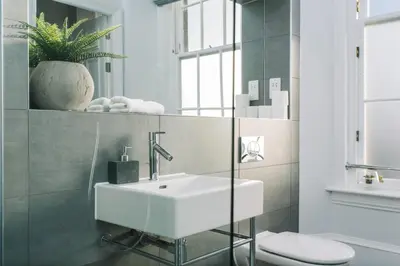 a bathroom with a white sink and a toilet at JOIVY Modern 1 bed flat next to Haymarket Station in Edinburgh