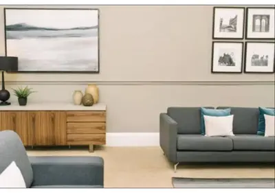 a living room with a couch and a table at JOIVY Elegant New Town Flat near Princes Street in Edinburgh