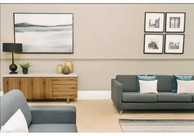 a living room with a couch and a table at JOIVY Elegant New Town Flat near Princes Street in Edinburgh