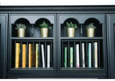 a book shelf with books and potted plants on it at JOIVY Elegant New Town Flat near Princes Street in Edinburgh