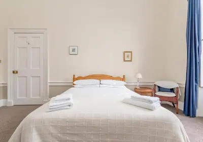 a bedroom with a bed with two towels on it at Melville Street Apartment in Edinburgh
