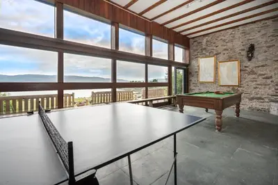 a ping pong table in a room with a pool table at Crispie House in Kilfinan