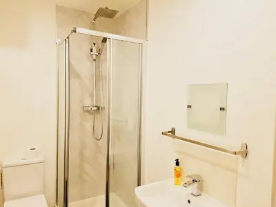 a bathroom with a shower and a sink at Glasgow Central Station SKYLINE Apartment with Parking (2 bedrooms, 2 bathrooms, 1 living room-Kitchen) in Glasgow