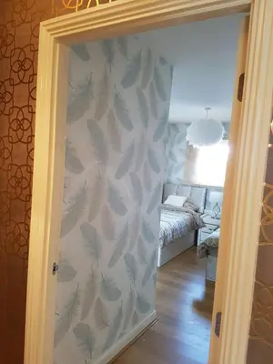 a room with a wall with leaves painted on it at Glasgow Central Station SKYLINE Apartment with Parking (2 bedrooms, 2 bathrooms, 1 living room-Kitchen) in Glasgow