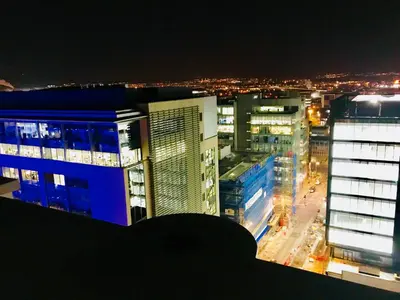 a view of a city at night with buildings at Glasgow Central Station SKYLINE Apartment with Parking (2 bedrooms, 2 bathrooms, 1 living room-Kitchen) in Glasgow
