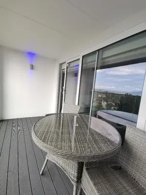 a rattan table and chairs on a balcony at Seamill House Hotel in Seamill