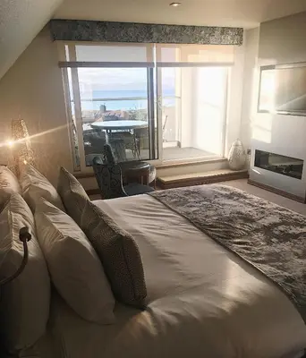 a bedroom with a large bed and a large window at Seamill House Hotel in Seamill