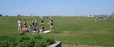 a group of people standing in a field at Charlotte Street 2 Bedroom Apartment in Ayr