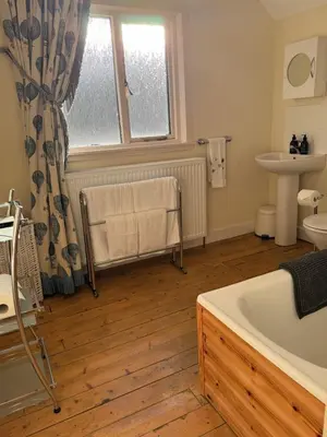a bathroom with a bath tub and a sink at The Sheiling in Saint Fillans
