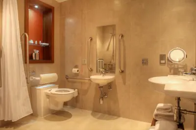 a bathroom with a toilet and a sink and a shower at Hotel Indigo Glasgow by IHG in Glasgow