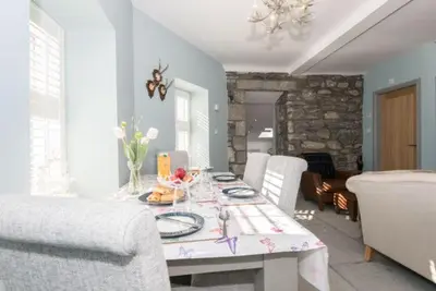 a dining room with a table and chairs at The Toll House in Newton Stewart