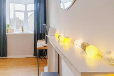 a row of yellow bowls on a counter in a room at Linlithgow Apartment in Linlithgow