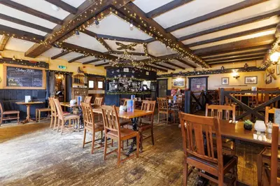 a dining room with wooden tables and chairs at Village Inn in Arrochar