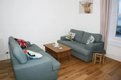 a living room with two couches and a table at The Lookout in Helensburgh