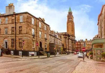 a street in a city with a clock tower at Luxury apartment, Stafford Street in Edinburgh