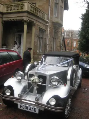 an old car parked in front of a building at Newhall in Glasgow