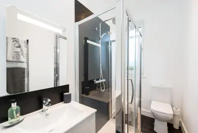 a bathroom with a sink and a shower and a toilet at The Roseburn Apartment in Edinburgh