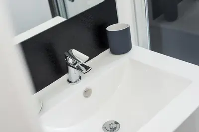 a bathroom sink with a faucet in front of a mirror at The Roseburn Apartment in Edinburgh