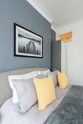 a bedroom with a bed with two pillows on it at The Roseburn Apartment in Edinburgh