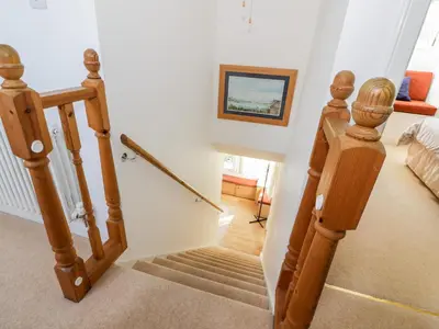 a staircase in a home with a stair case at Glen Euchar House in Kilninver