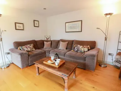 a living room with a couch and a coffee table at Muirmailing Cottage in Plean