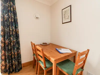 a dining room with a wooden table and chairs at Forester's Cottage in Newyork