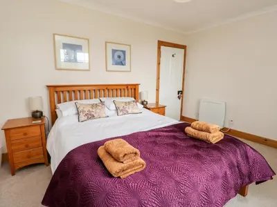 a bedroom with a bed with two towels on it at Forester's Cottage in Newyork