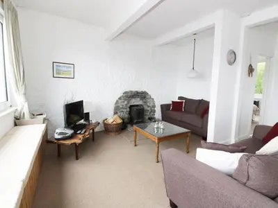 a living room with a couch and a fireplace at Top Flat in Tighnabruaich