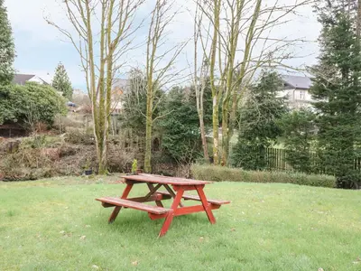 a picnic table sitting in the grass in a yard at The Knowe Upper in Taynuilt