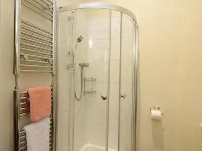 a shower with a glass door in a bathroom at Tulchan Lodge in Buchanty