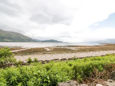 a view of the shoreline of a body of water at Pebble Nook in Onich