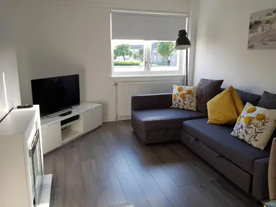 a living room with a couch and a tv at Flemming Place in East Kilbride