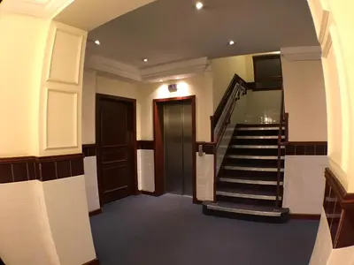 a hallway with a staircase in a building at Central West End City Apartment in Glasgow