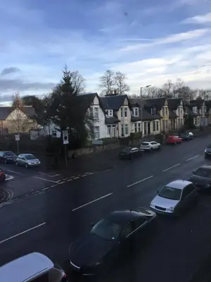 a street with cars parked on the side of a road at Scotstoun 1 Bed Flat in Glasgow
