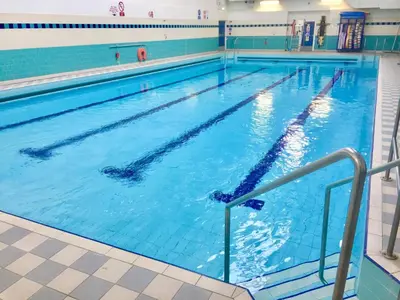 a large swimming pool with blue water at RIVER CLYDE VIEWS - PRIVATE & SPACIOUS APARTMENT in Port Glasgow