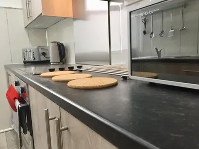 a kitchen with a counter with three cookies on it at RIVER CLYDE VIEWS - PRIVATE & SPACIOUS APARTMENT in Port Glasgow