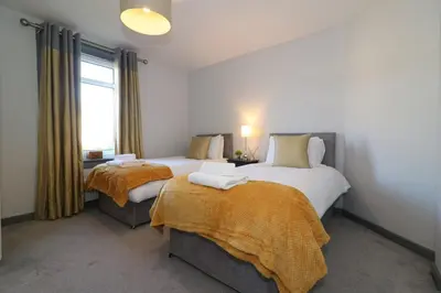 a bedroom with two beds and a window at Signature - Burnbank House in Hamilton