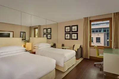 a hotel room with two beds and a window at Sheraton Grand Hotel & Spa in Edinburgh