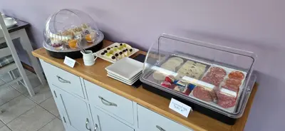 a counter with meat and other food items on it at Craigbank Guest House in Crianlarich