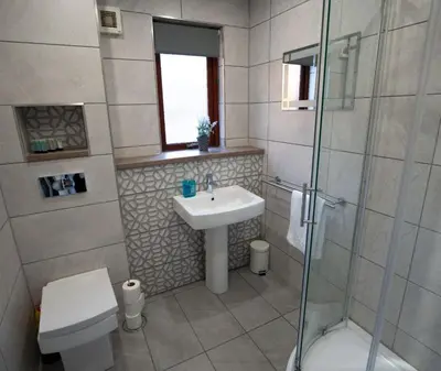 a bathroom with a sink and a toilet and a shower at One Bedroom ground floor flat in Stirling