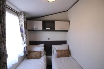 a small room with two beds and a window at Jackson Lodge in Perth