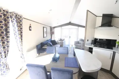 a kitchen and living room with a table and chairs at Jackson Lodge in Perth