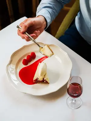 a person is eating a piece of dessert on a plate at The Fortingall in Kenmore