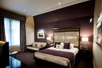 a hotel room with a bed and a couch at Seamill Hydro Hotel in Seamill