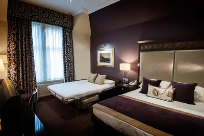 a hotel room with two beds and a window at Seamill Hydro Hotel in Seamill
