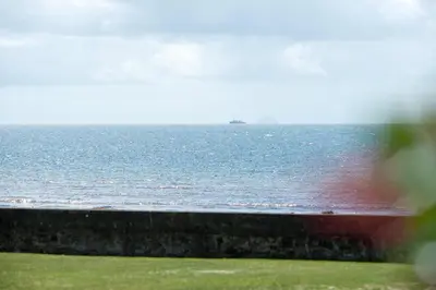 a view of the ocean with a boat in the water at Seamill Hydro Hotel in Seamill