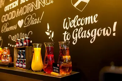 a shelf with three different colored vases on it at Motel One Glasgow in Glasgow
